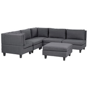 Divano componibile a 5 posti imbottito lato destro in tessuto grigio scuro con gambe nere e pouf stile moderno