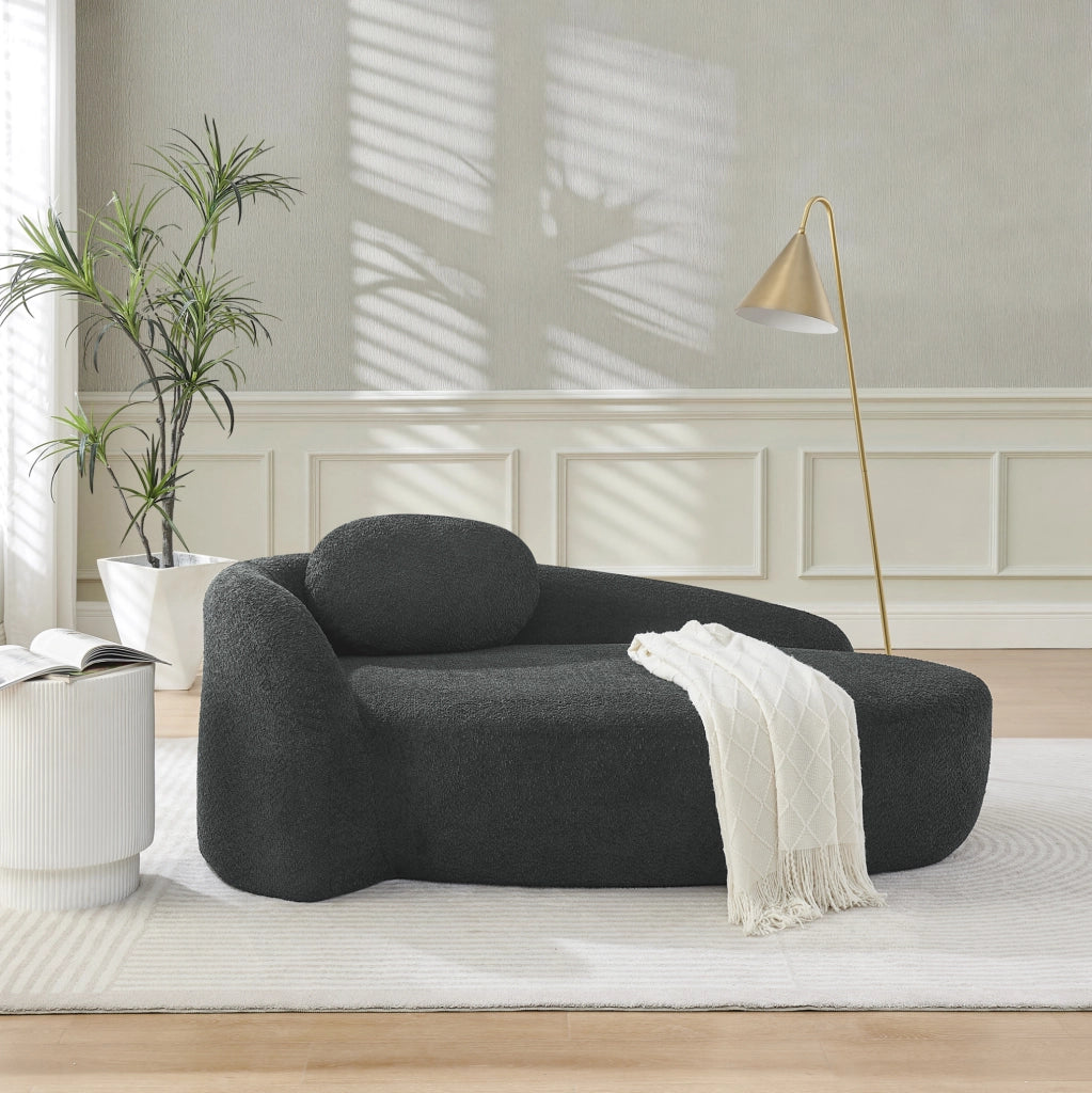 Divano minimalista in tessuto Teddy nero, compatto e confortevole