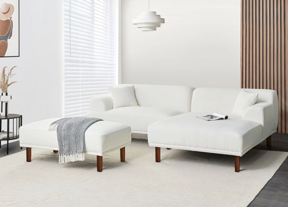 Divano ad angolo sinistro in tessuto bianco lato sinistro con pouf stile minimalista