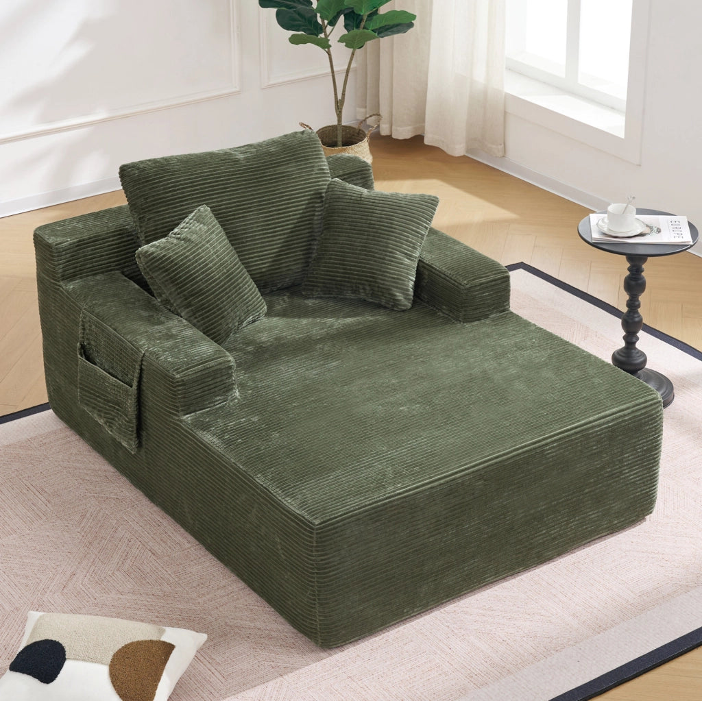 Divano in corduroy verde con tasche laterali e cuscini