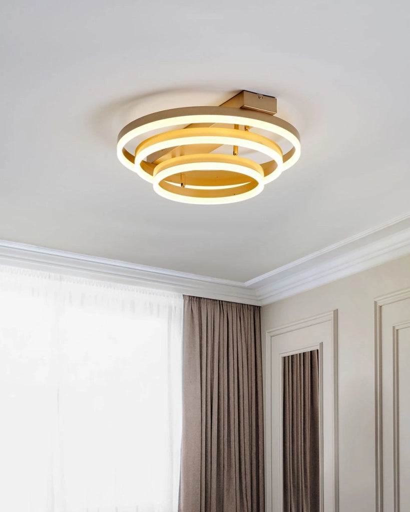 Plafoniera in alluminio color oro con luci LED integrate forma rotonda stile glam contemporaneo