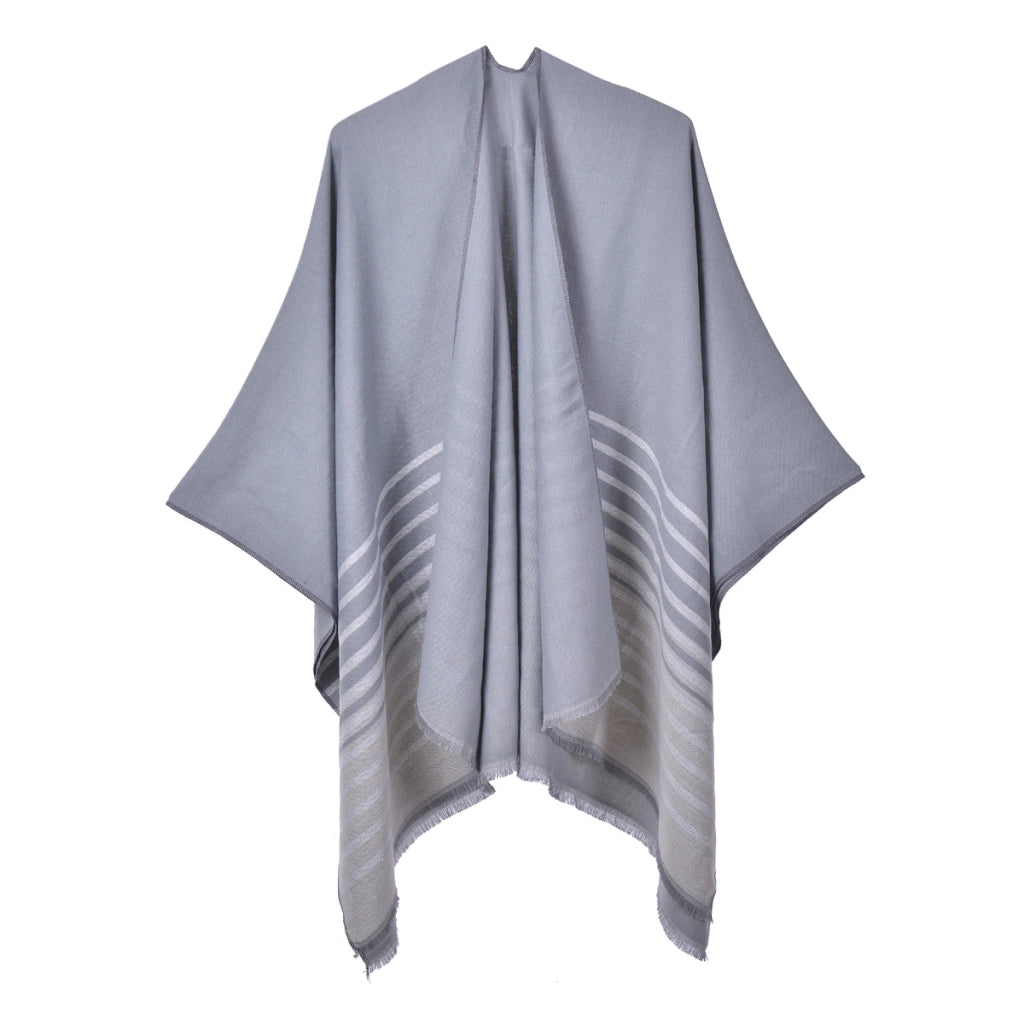 Mantella calda da donna reversibile in maglia con spacco e nappine.