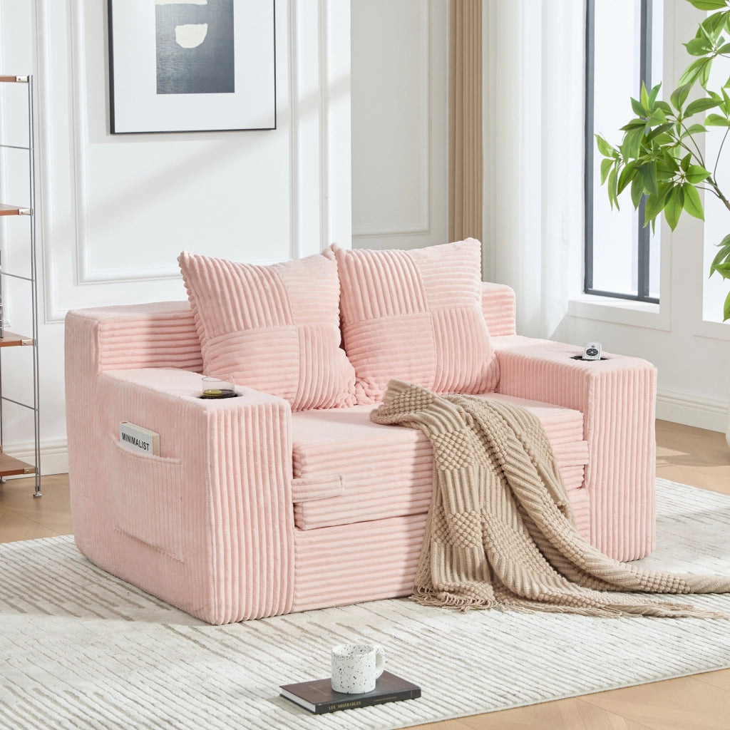 Divano pouf in velluto a coste rosa con due cuscini tasche laterali e braccioli