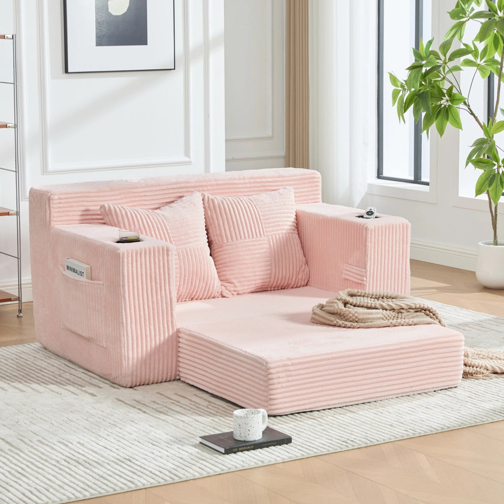 Divano pouf in velluto a coste rosa con due cuscini tasche laterali e braccioli