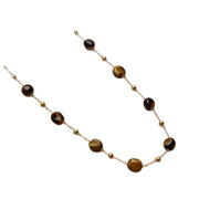 Collana in stile boh¨¦mien minimalista con perline di ambra effetto tartaruga.