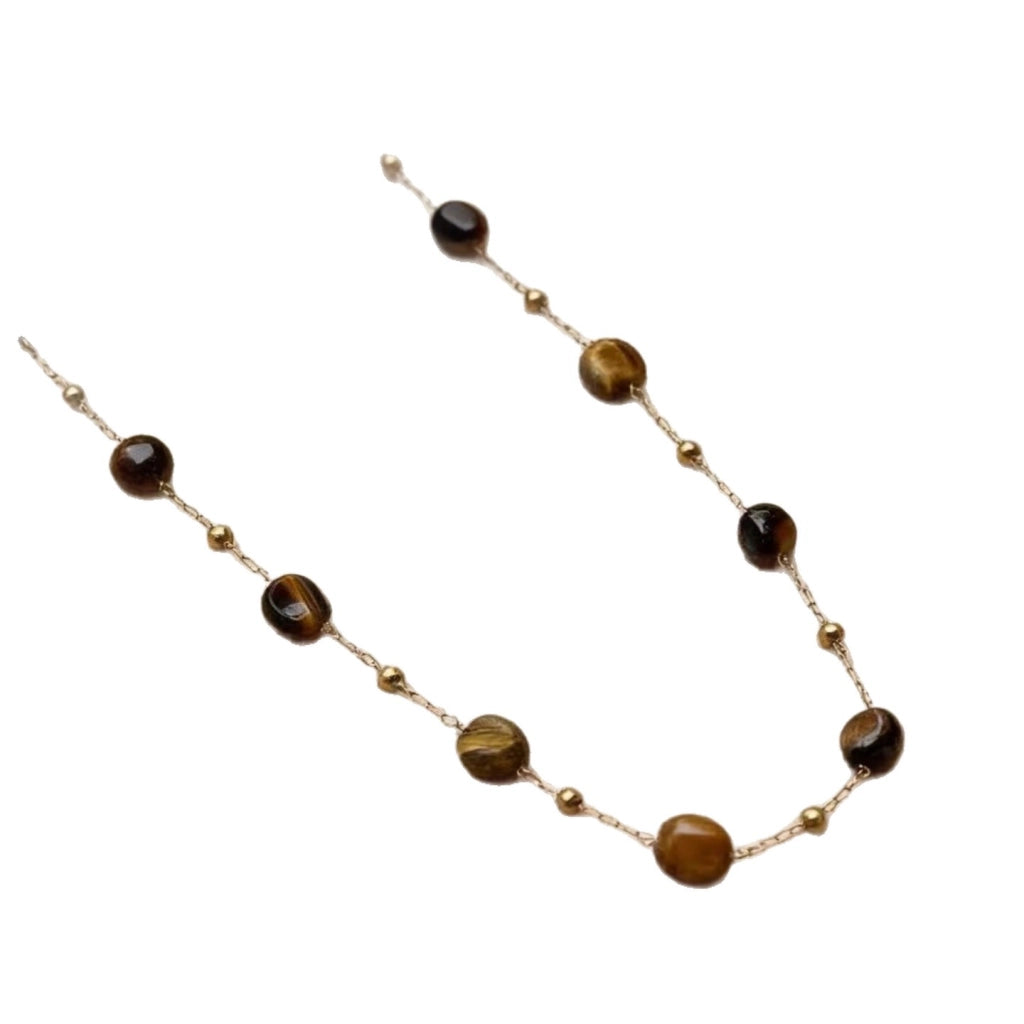 Collana in stile boh¨¦mien minimalista con perline di ambra effetto tartaruga.