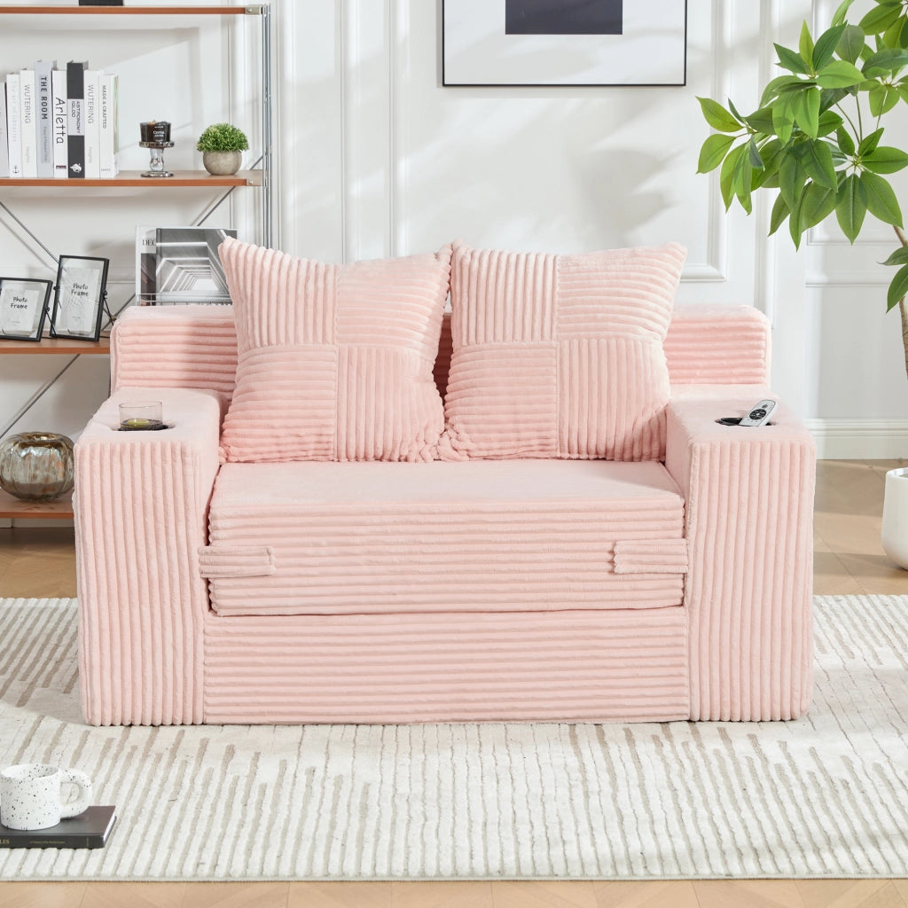 Divano pouf in velluto a coste rosa con due cuscini tasche laterali e braccioli
