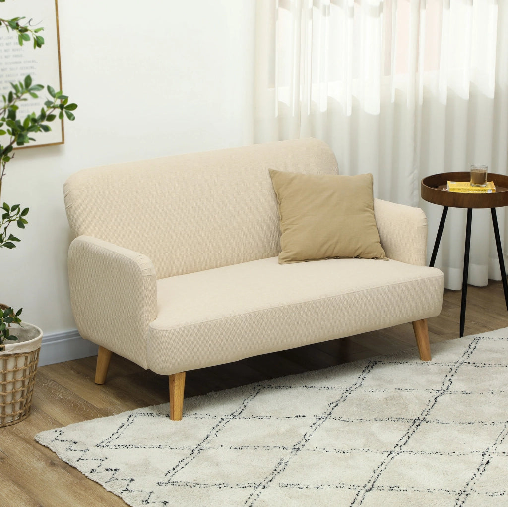 Divano compatto a due posti in velluto color crema con gambe in legno