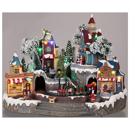 Villaggio natalizio con treno in movimento, negozi, luci e musica (4