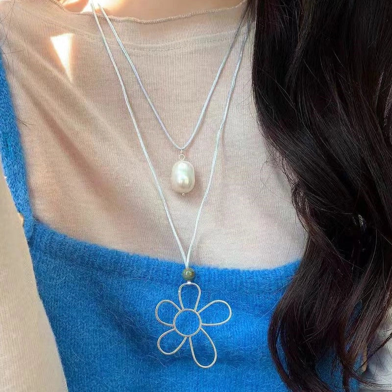 Collana a strati di fiori in argento traforato con pendente in perla barocca e catena per clavicola