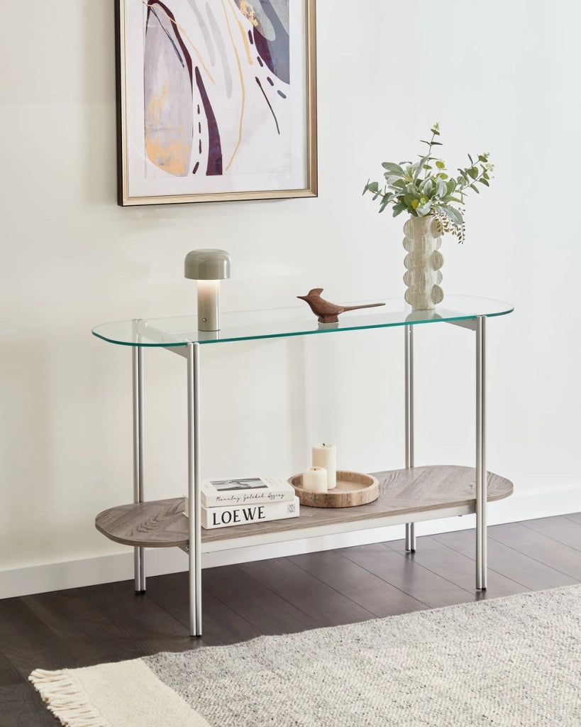 Tavolo console con piano in vetro temperato e struttura in metallo 1 ripiano in legno chiaro e argento stile moderno