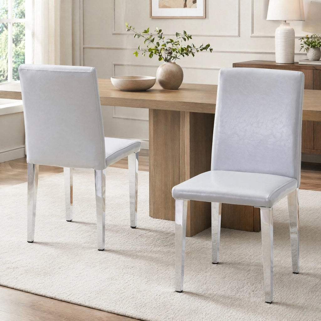 Set 2 sedie da pranzo moderne in PU grigio chiaro con gambe in metallo argentato; h 90 cm