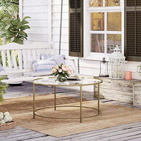 Tavolino da caffè rotondo Valora con struttura in acciaio dorato e piano in vetro