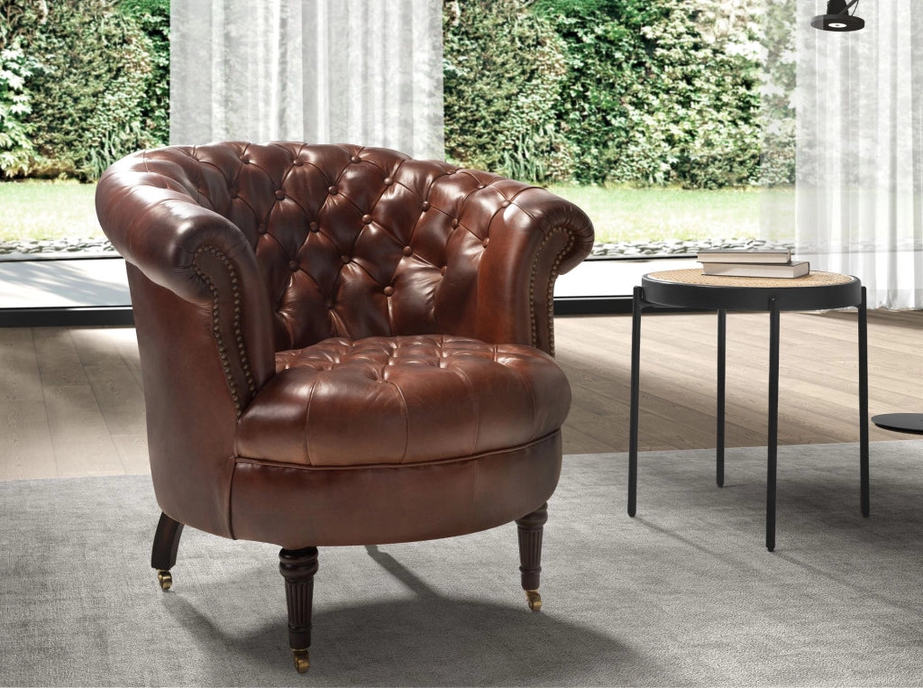 Poltrona Chester con seduta circolare in pelle marrone cognac