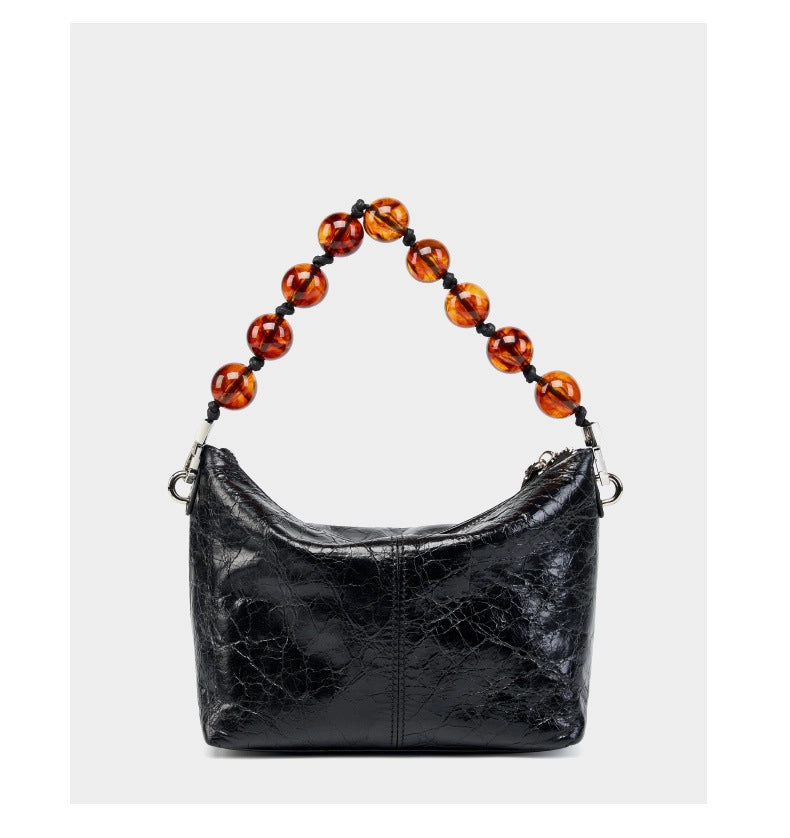 Borsa a mano plissettata in vera pelle vintage cerata, nera.