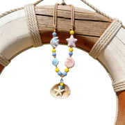Collana con ciondolo a forma di stella marina e conchiglia, ricca di dopamina.