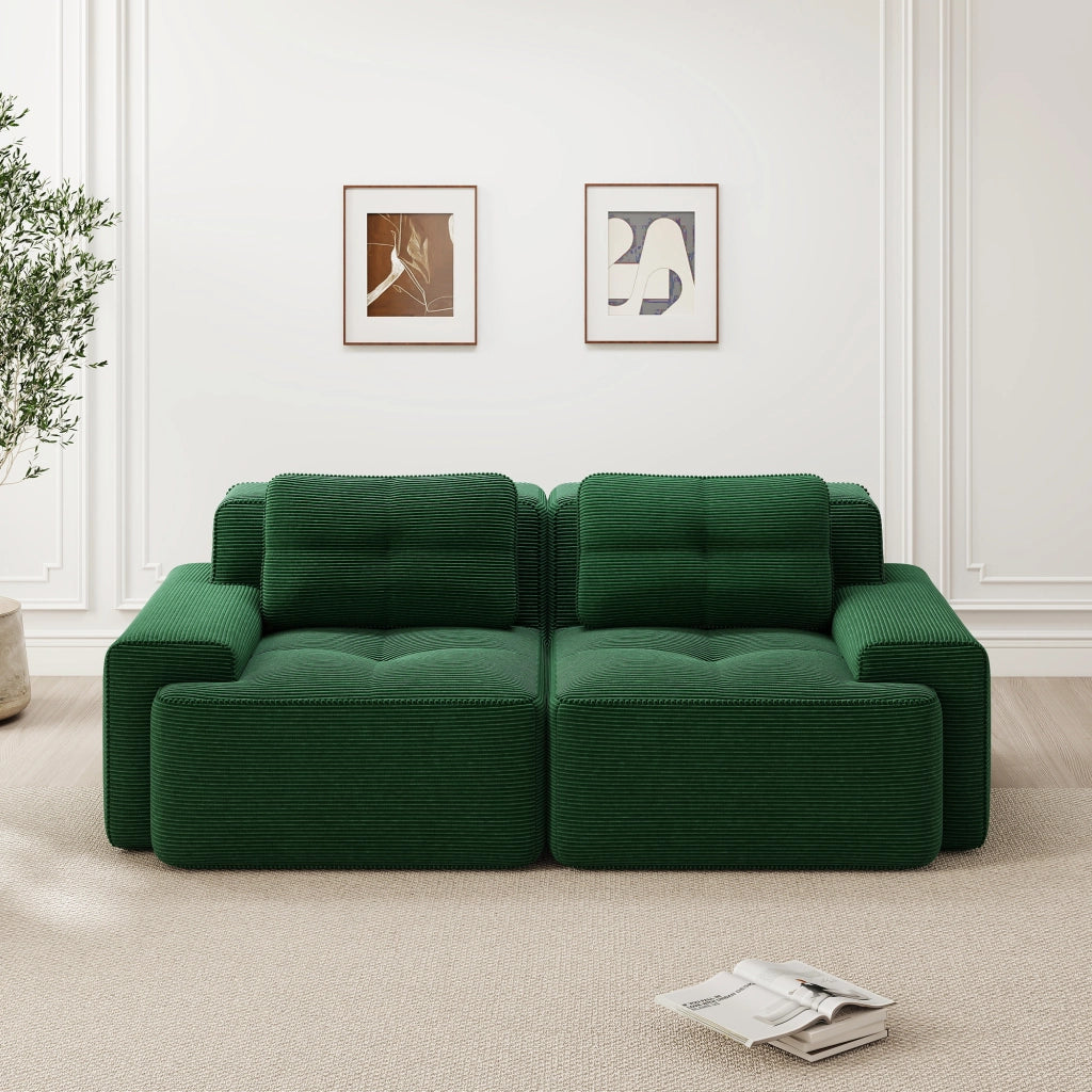 divano modulare lounge con seduta profonda; ampi braccioli; in velluto a coste; verde