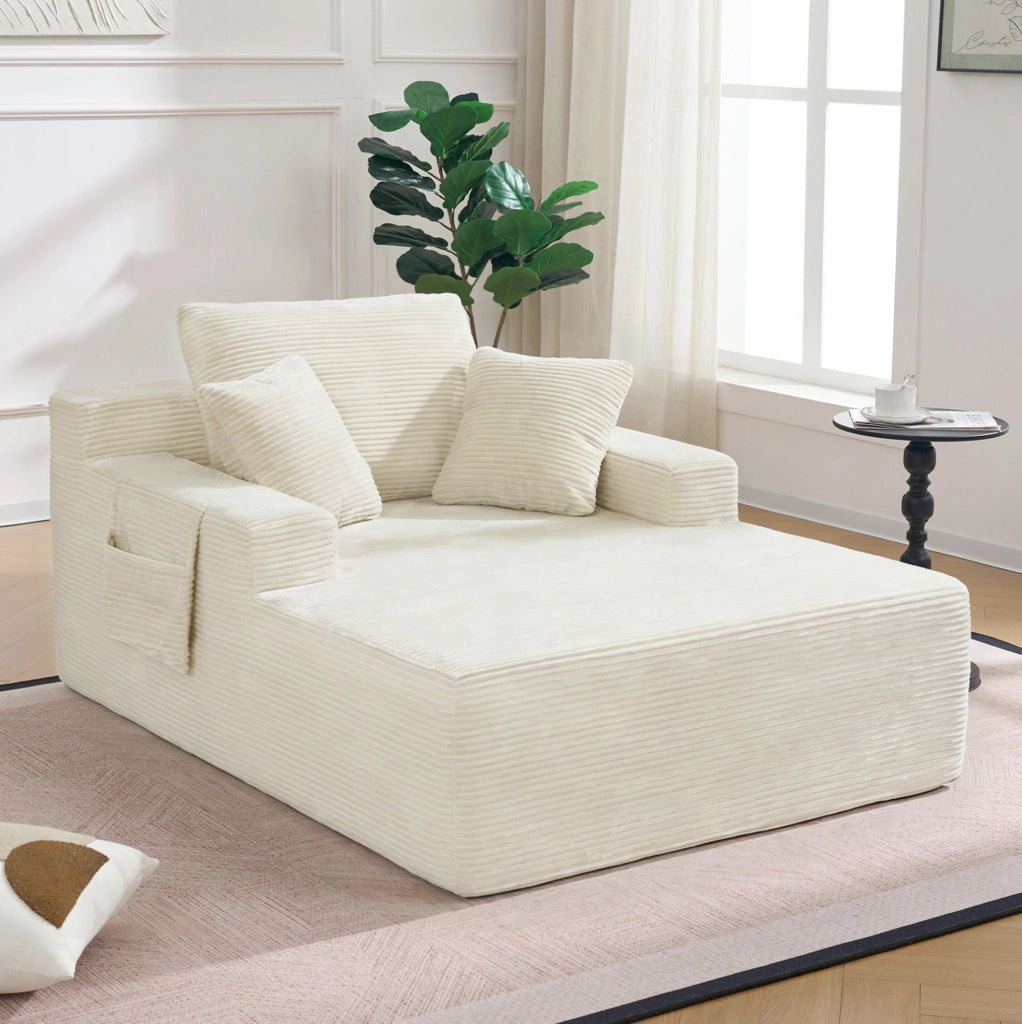 Divano compatto in cord beige con tasche laterali e cuscini