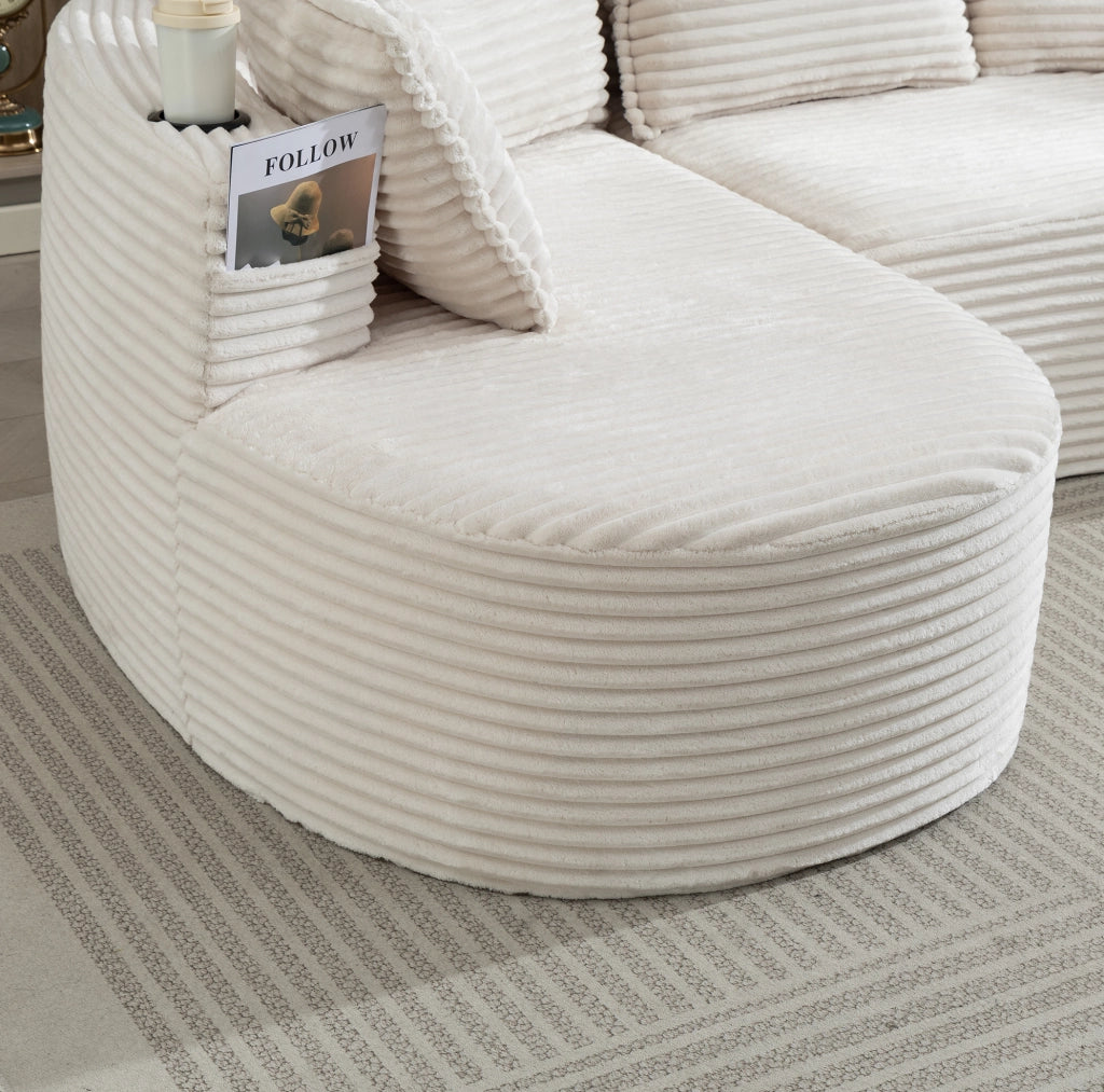 Divano curvo in velluto a coste beige con portabevande