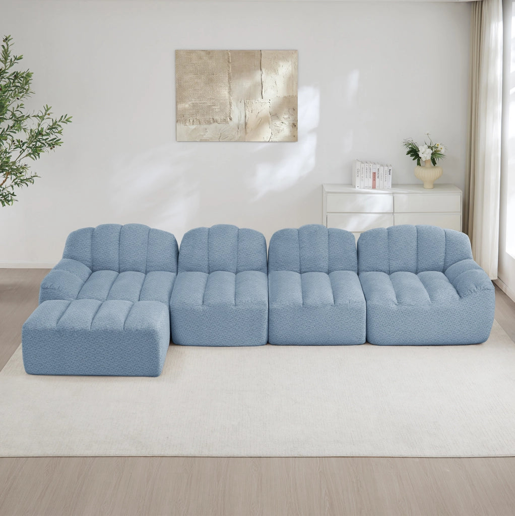 Divano modulare 4 posti con ottomana; design senza struttura in fleece granulato blu