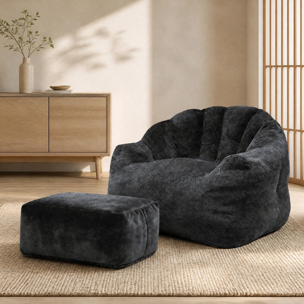Poltrona relax con pouf abbinato in flannelette nera, design a petalo