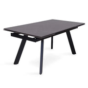 Tavolo da pranzo estensibile per 10 persone con piano in pietra nera della collezione LAROS. Struttura in metallo.