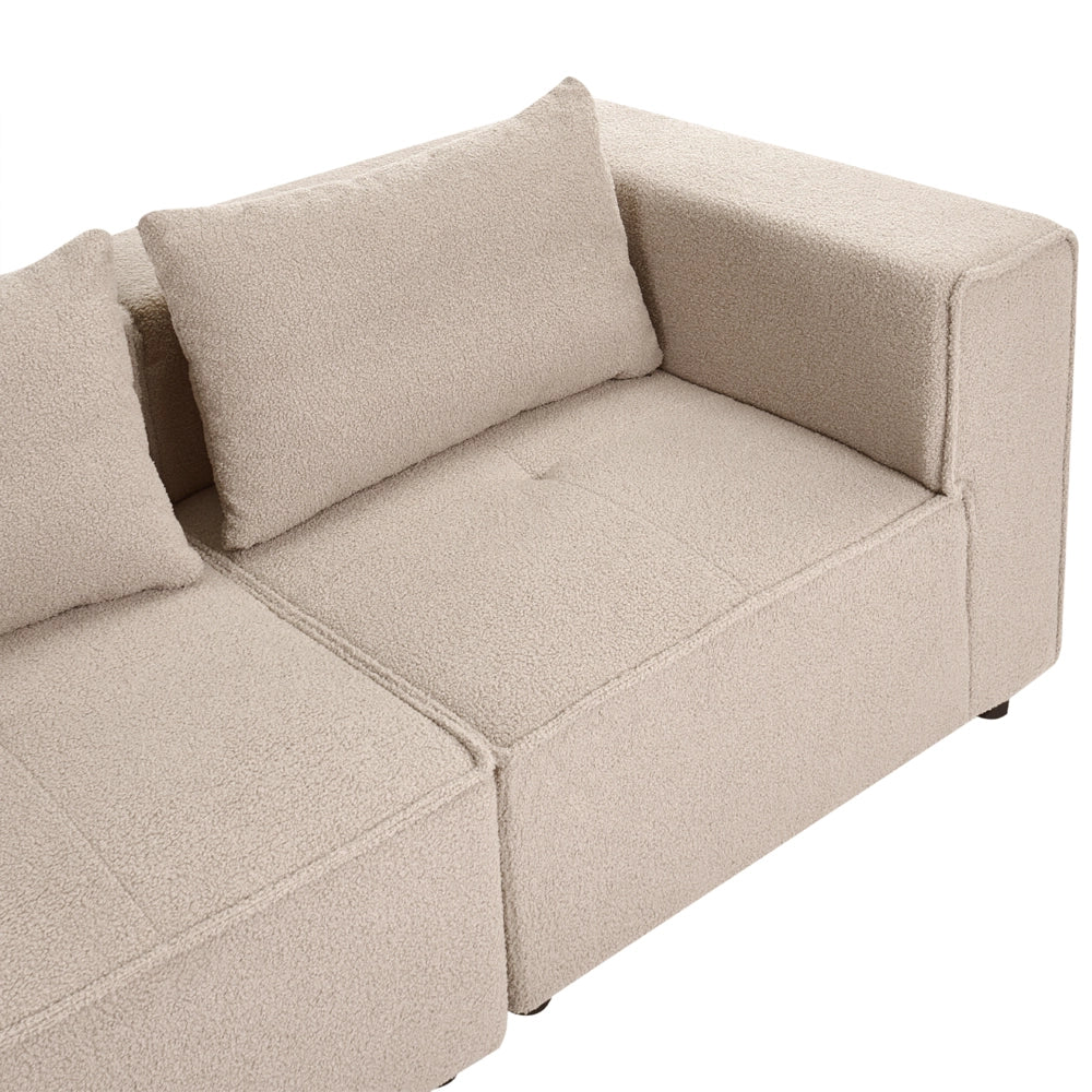 Divano a 4 posti in tessuto bouclè modulare beige lato sinistro stile minimale moderno