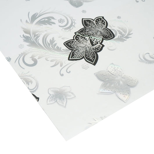 Rotolo pellicola protettiva per tavolo in PVC siliconato trasparente – modello floreale nero Materiale: PVC siliconato trasparente  Dimensioni rotolo: 1,00 × 20 m Breckner Germany