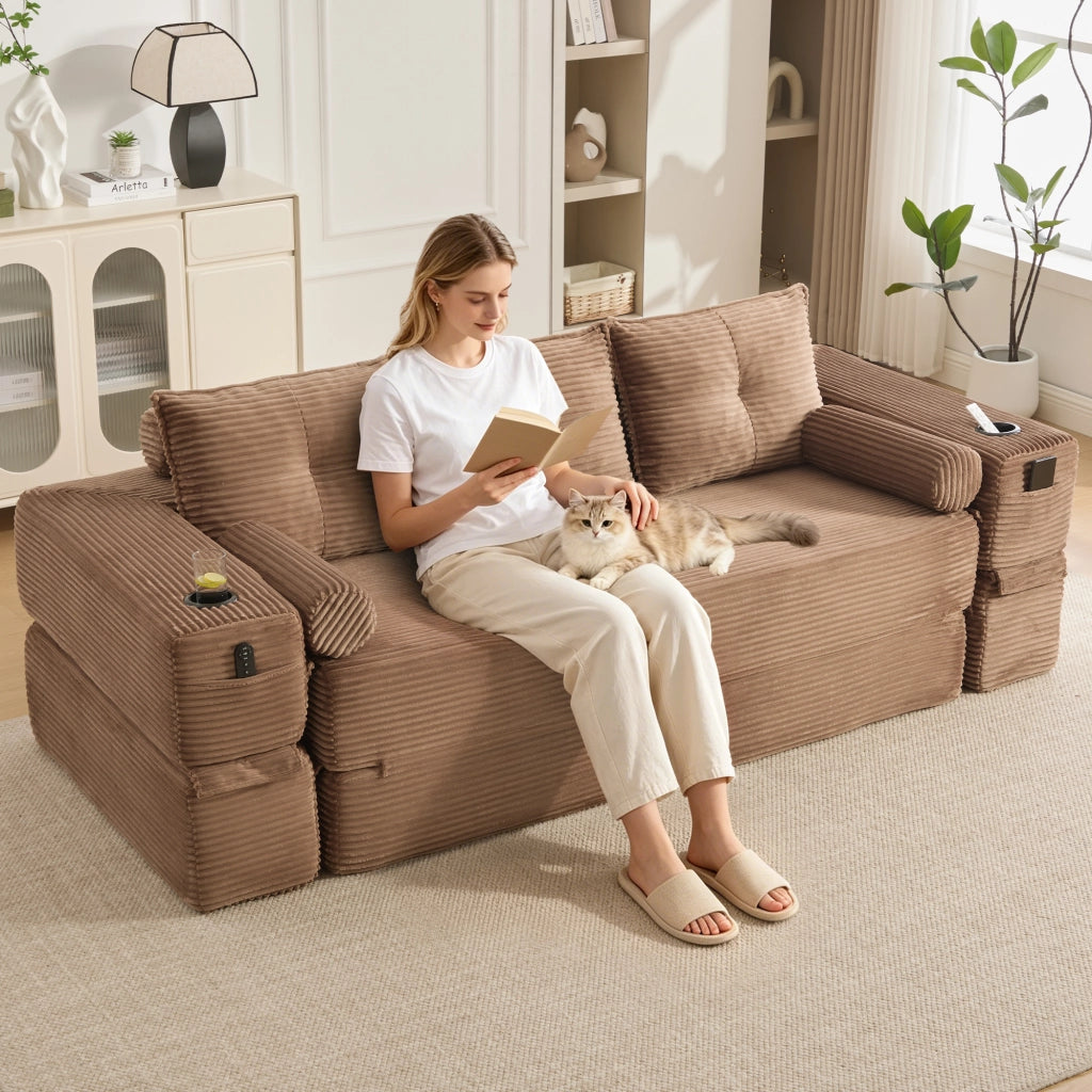 Divano letto modulare con cuscini memory, tasche laterali e portabicchieri in velluto a coste marrone per casa