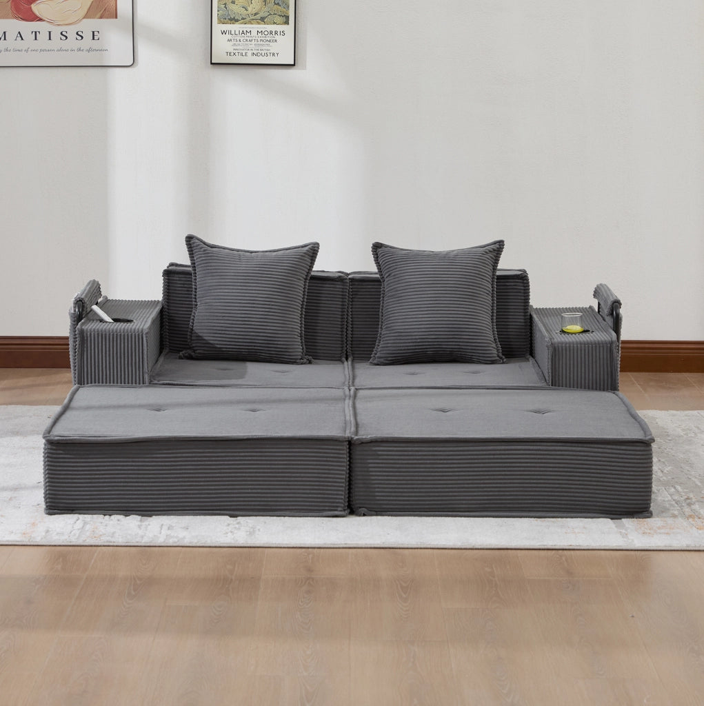 Pouf sofa modulare grigio scuro in velluto a coste con cuscini e tasche laterali