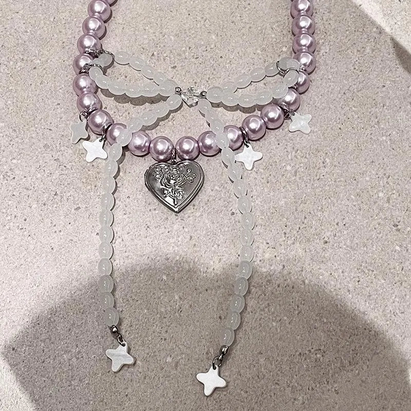 Collana con fiocco fatta a mano con perle rosa e viola.