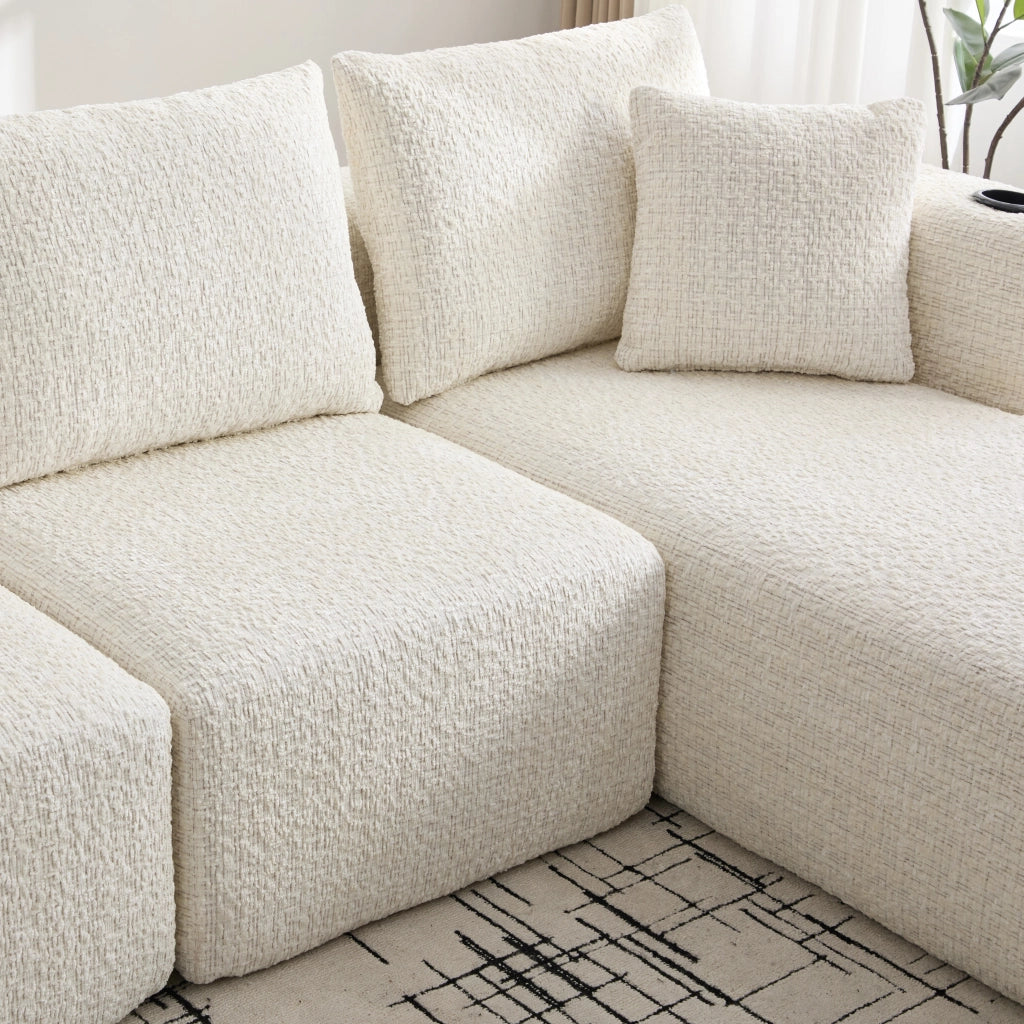 Divano componibile angolare a 3 posti in chenille beige con braccioli portaoggetti e tasche 261 × 165 × 80 cm