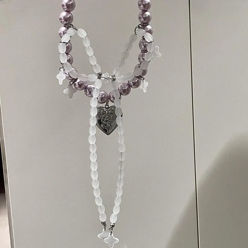 Collana con fiocco fatta a mano con perle rosa e viola.