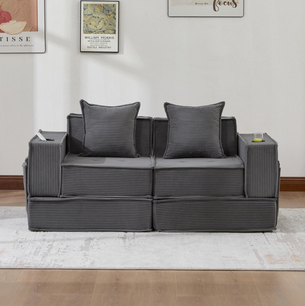 Pouf sofa modulare grigio scuro in velluto a coste con cuscini e tasche laterali