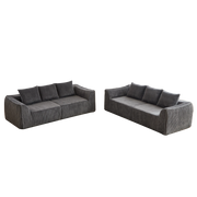 Divano modulare in velluto a coste con linee curve e cuscini in tessuto grigio