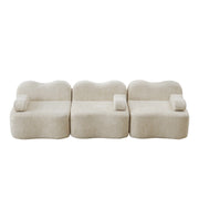 Divano modulare 3 posti con seduta profonda; forma ondulata e cuscino bracciolo mobile in velluto beige