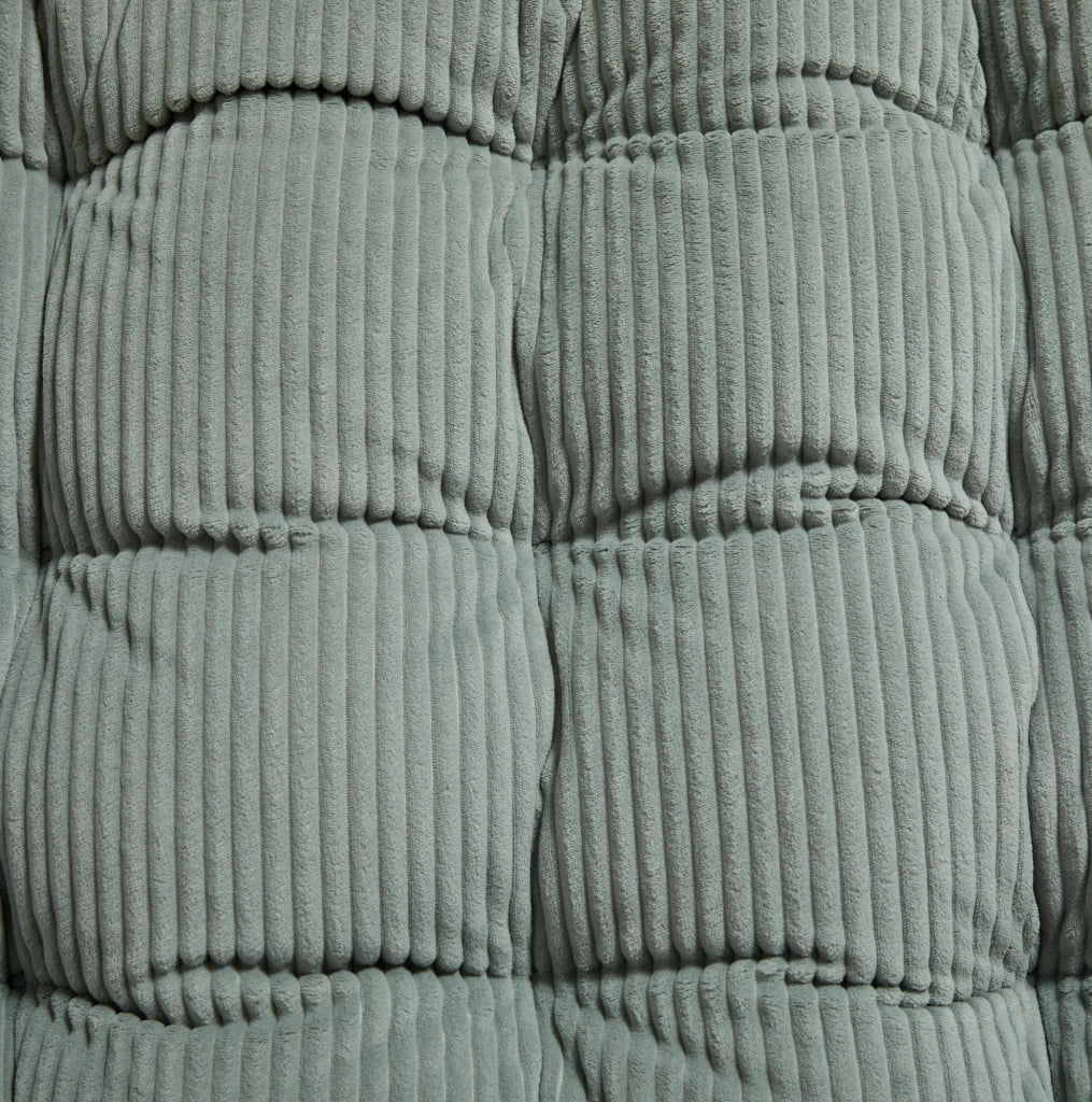 Poltrona a dondolo con pouf, struttura nera e cuscino verde chiaro