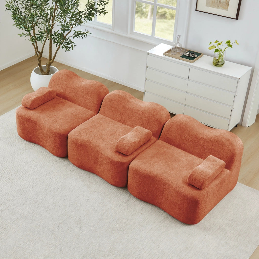 Divano modulare senza struttura con seduta profonda, schienali ergonomici e pouf collegabile in velluto arancione