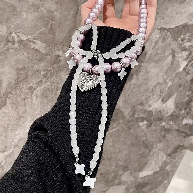 Collana con fiocco fatta a mano con perle rosa e viola.