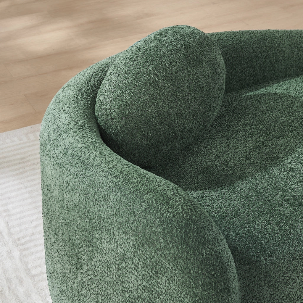 Divano compatto in Teddy verde con design arrotondato, cuscino di supporto e imbottitura elastica