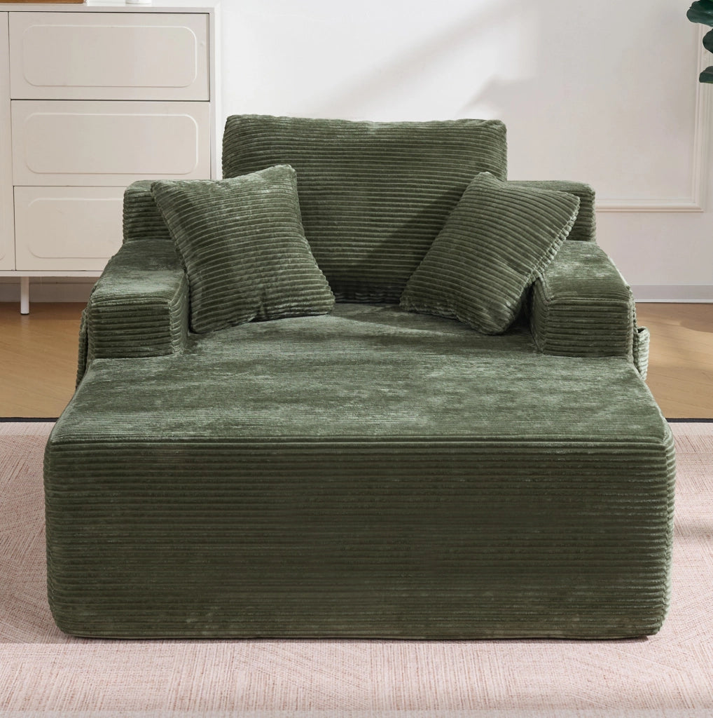 Divano in corduroy verde con tasche laterali e cuscini