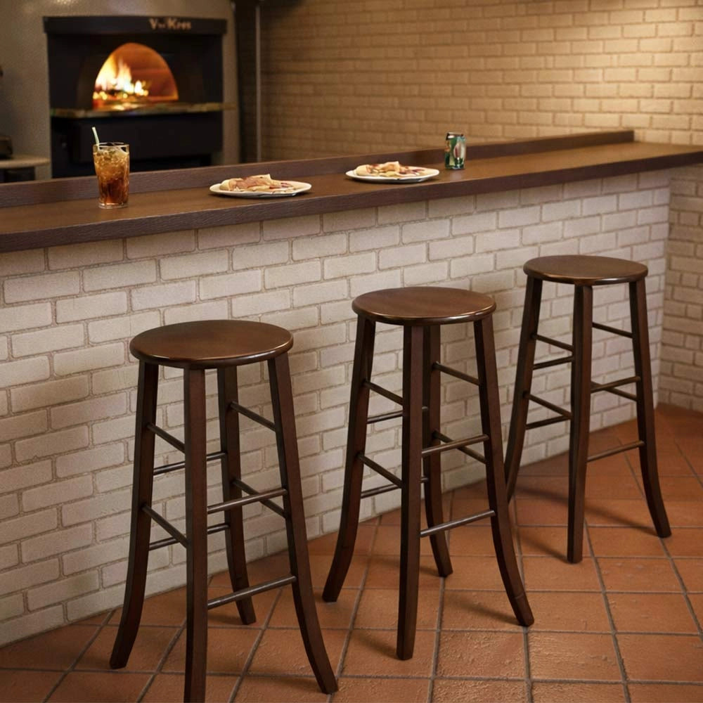 Sgabello H 80 cm in legno noce scuro con seduta rotonda e gambe a sciabola
