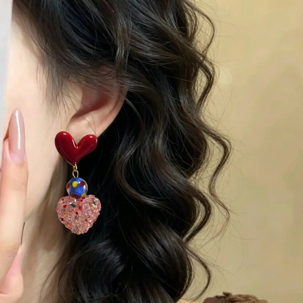 Orecchini rossi a forma di cuore con zucchero dopaminergico e cuore rosa tridimensionale.