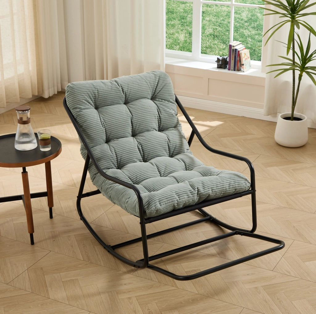 Poltrona a dondolo con pouf, struttura nera e cuscino verde chiaro