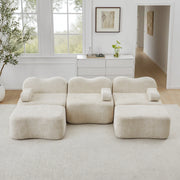 Divano angolare modulare componibile senza telaio con seduta profonda e pouf, in velluto beige per soggiorno familiare