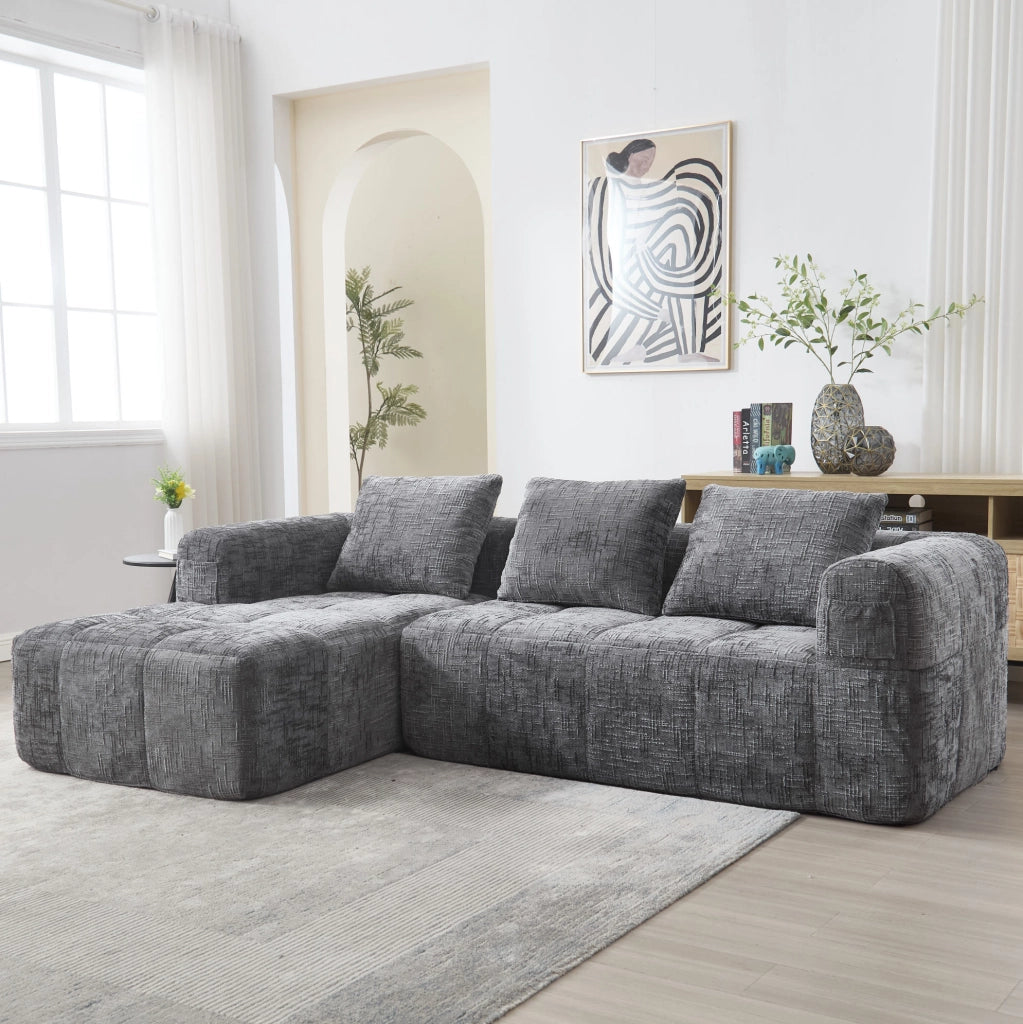Divano componibile grigio in ciniglia con chaise longue e tasche