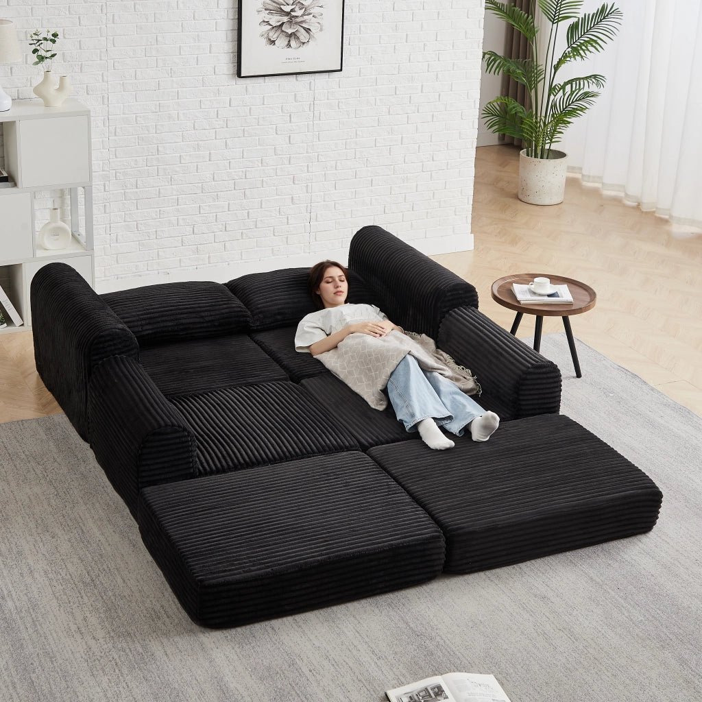 Divano letto modulare con pouf rimovibile e braccioli curvi, configurazione flessibile in velluto a coste nero