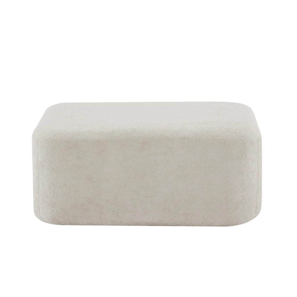 Divano modulare beige in velluto; seduta profonda con pouf collegabile