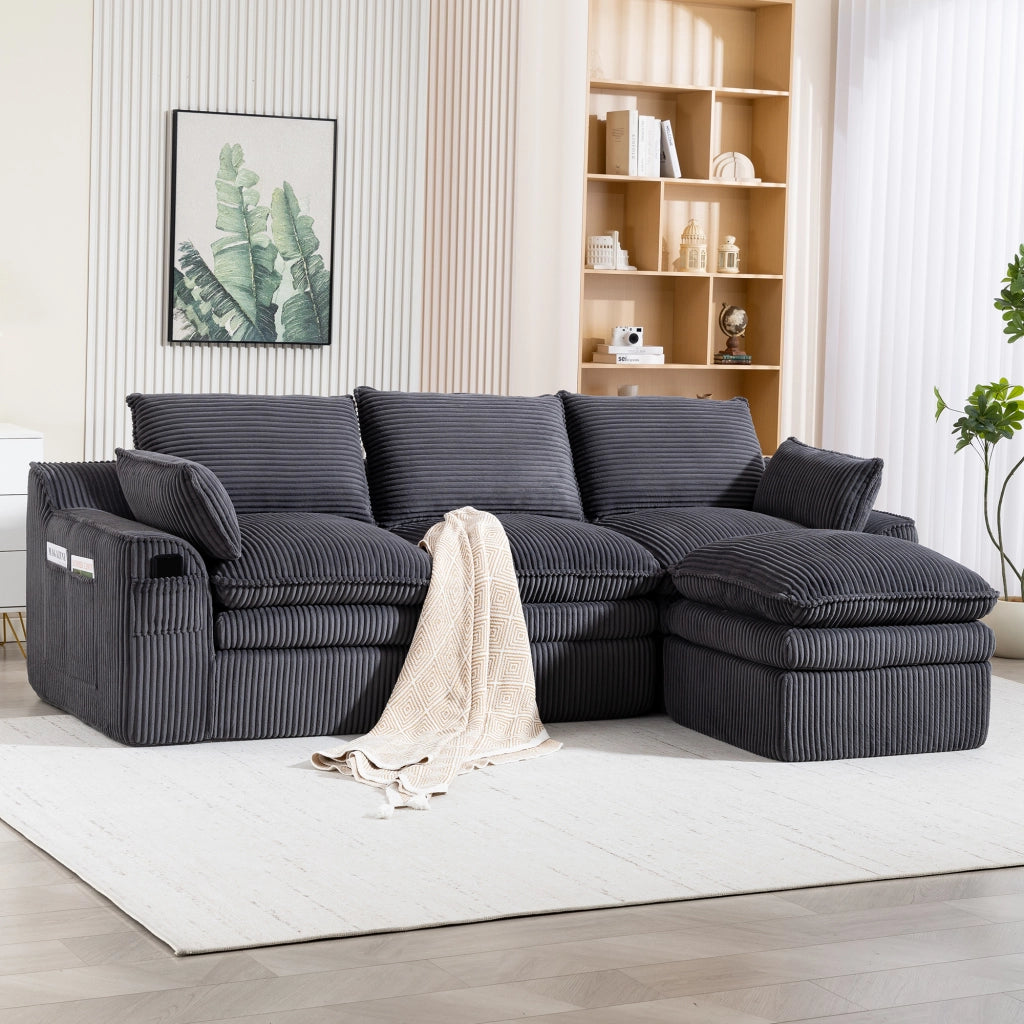 Divano modulare in corduroy grigio scuro con cuscini, tasche laterali e poggiapiedi