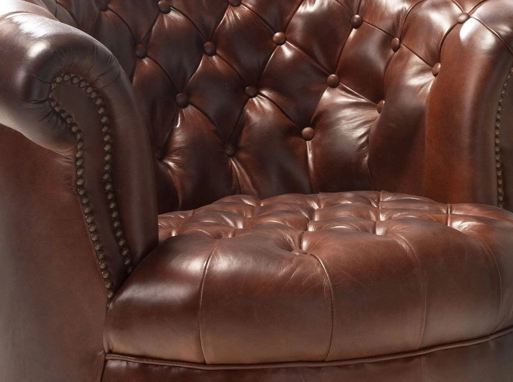 Poltrona Chester con seduta circolare in pelle marrone cognac